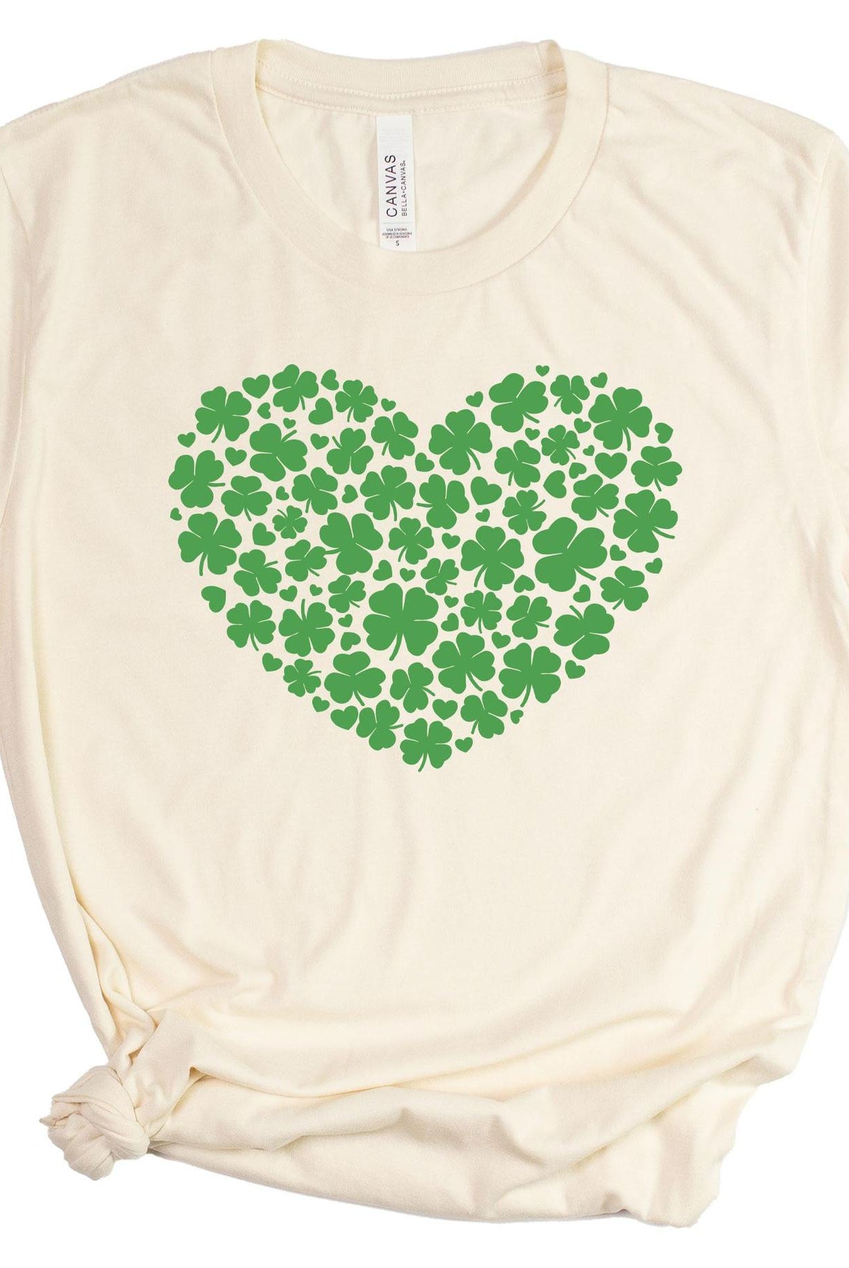Beige t-shirt with a green heart-shaped pattern of clovers on a white background