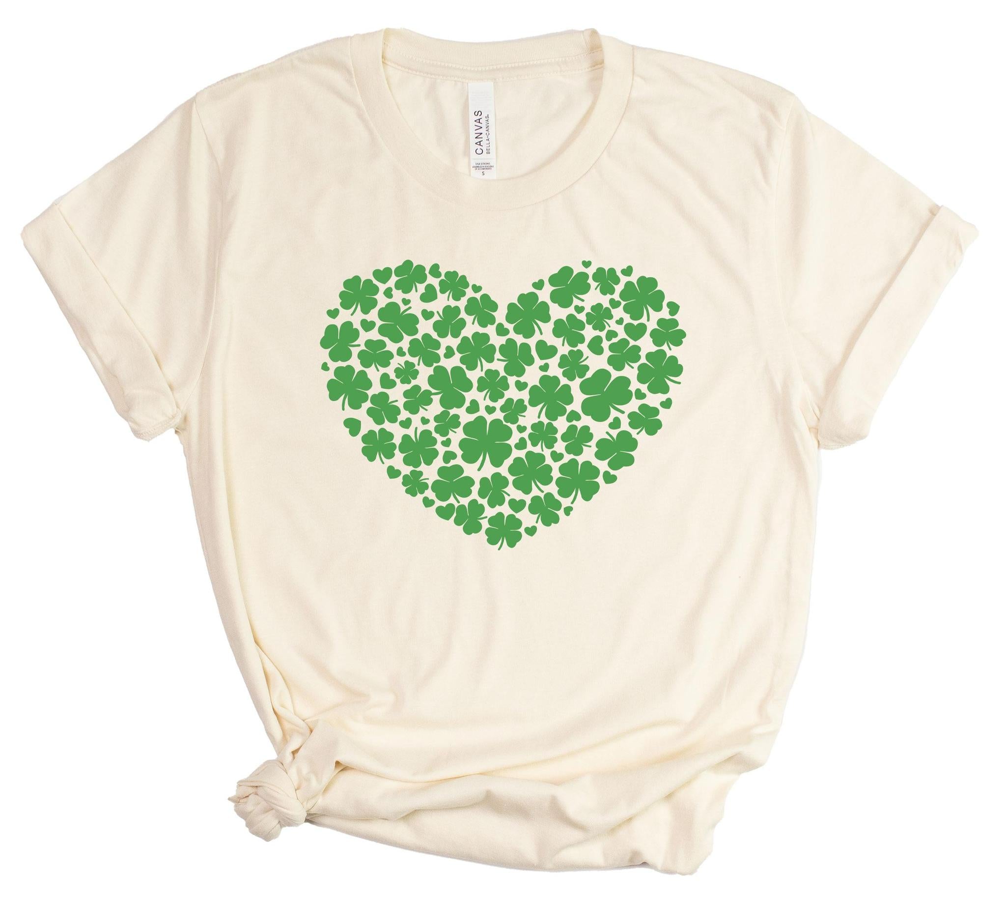 Beige t-shirt with a green heart-shaped pattern of clovers on a white background