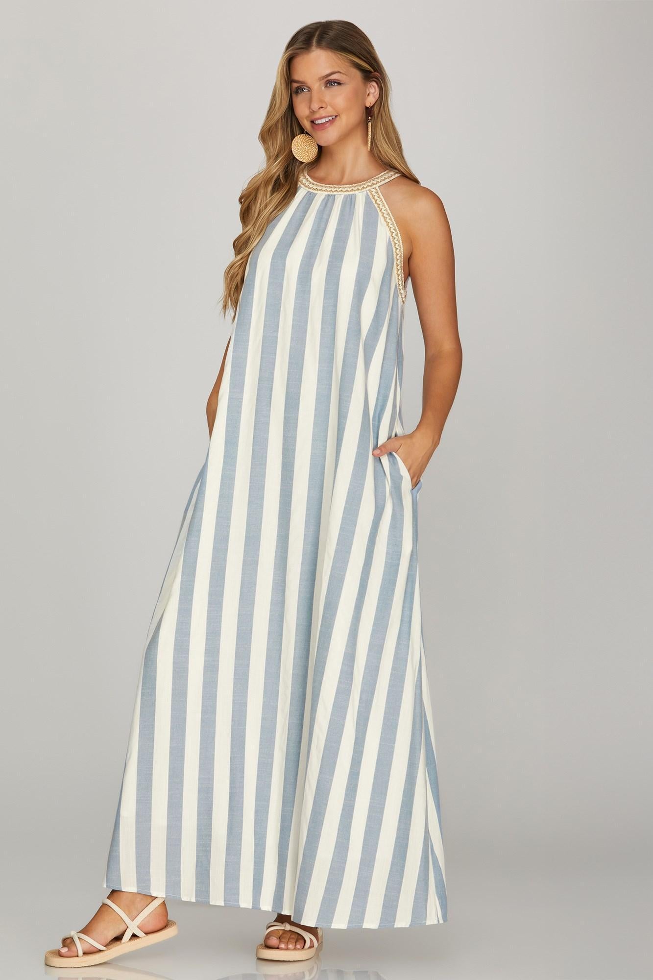 Woman wearing a blue and white striped dress on a gray background