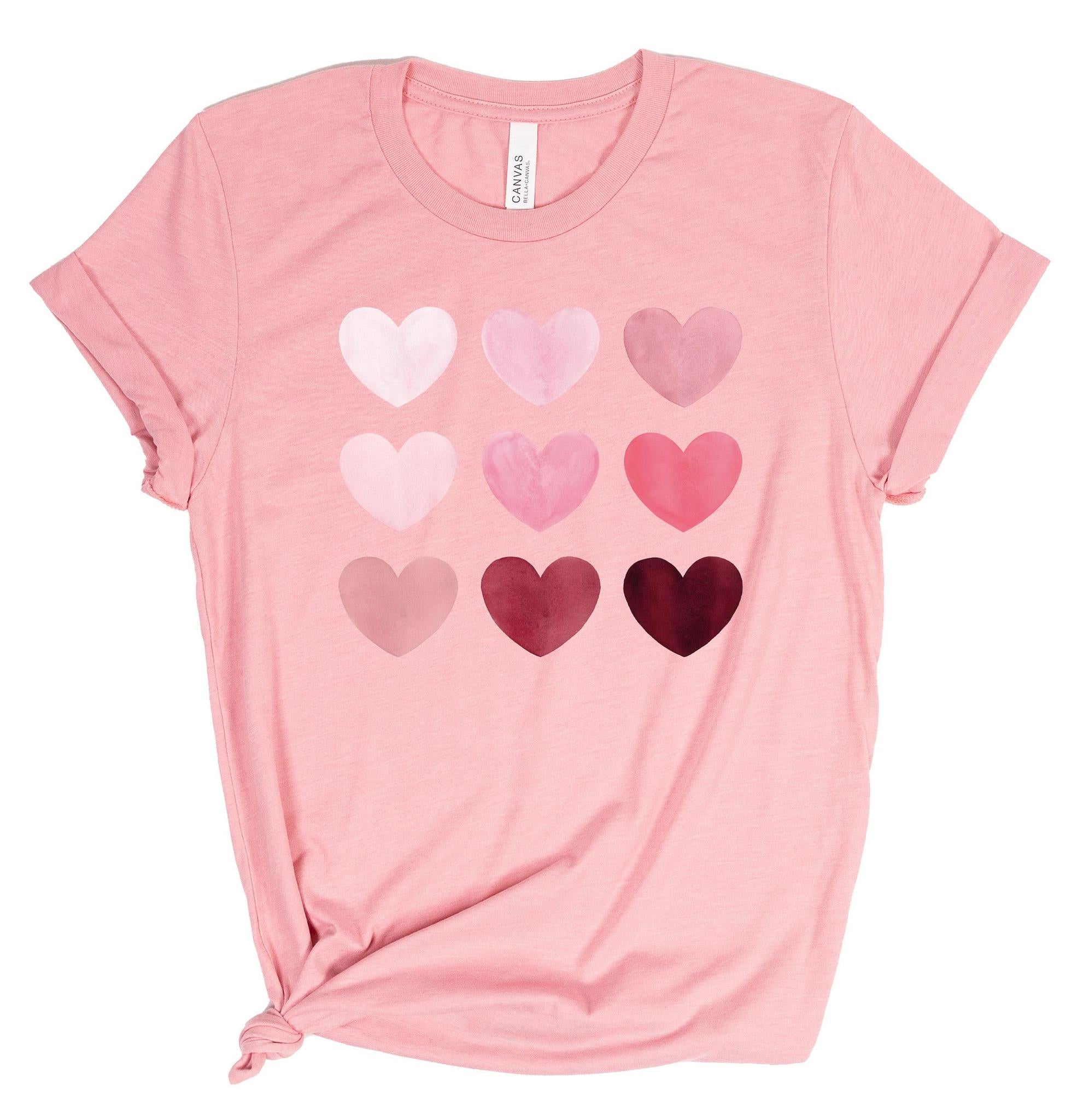Pink t-shirt with heart pattern on a white background
