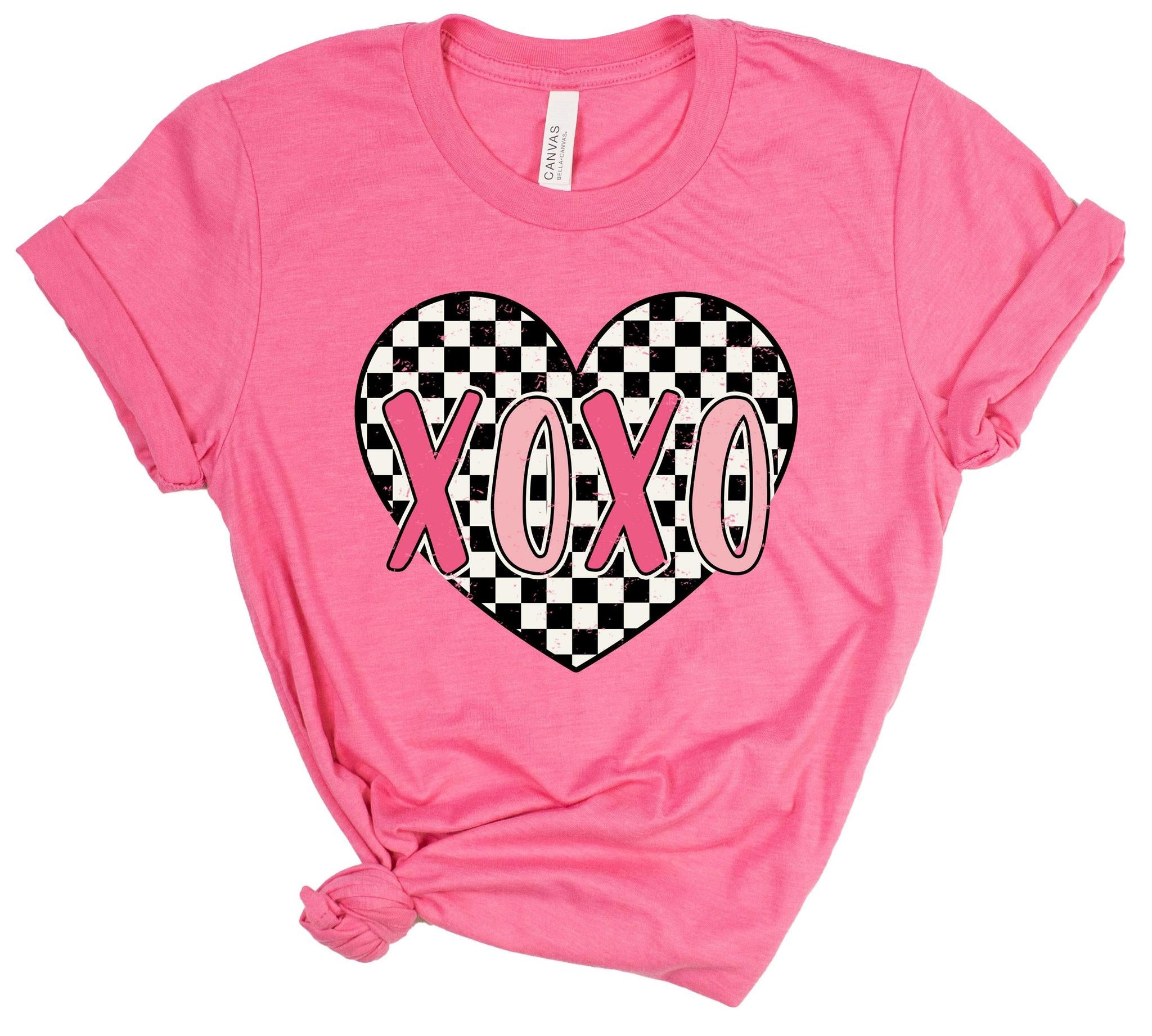 Pink t-shirt with a checkered heart and 'XOXO' text on a white background