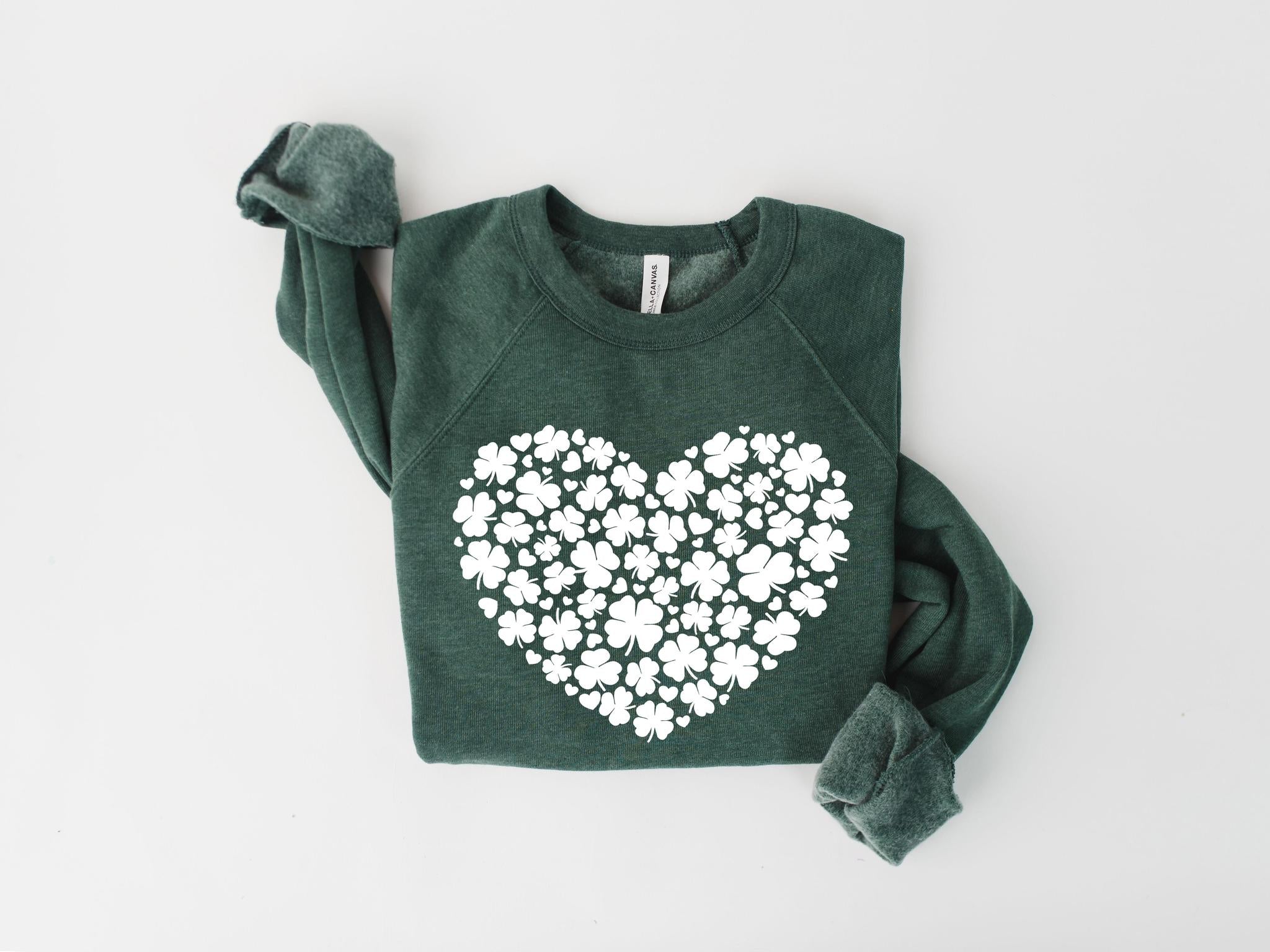 Green sweatshirt with a white heart-shaped pattern on a light gray background