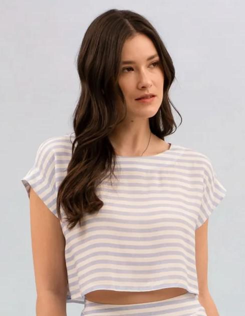 Woman wearing a striped shirt against a plain background