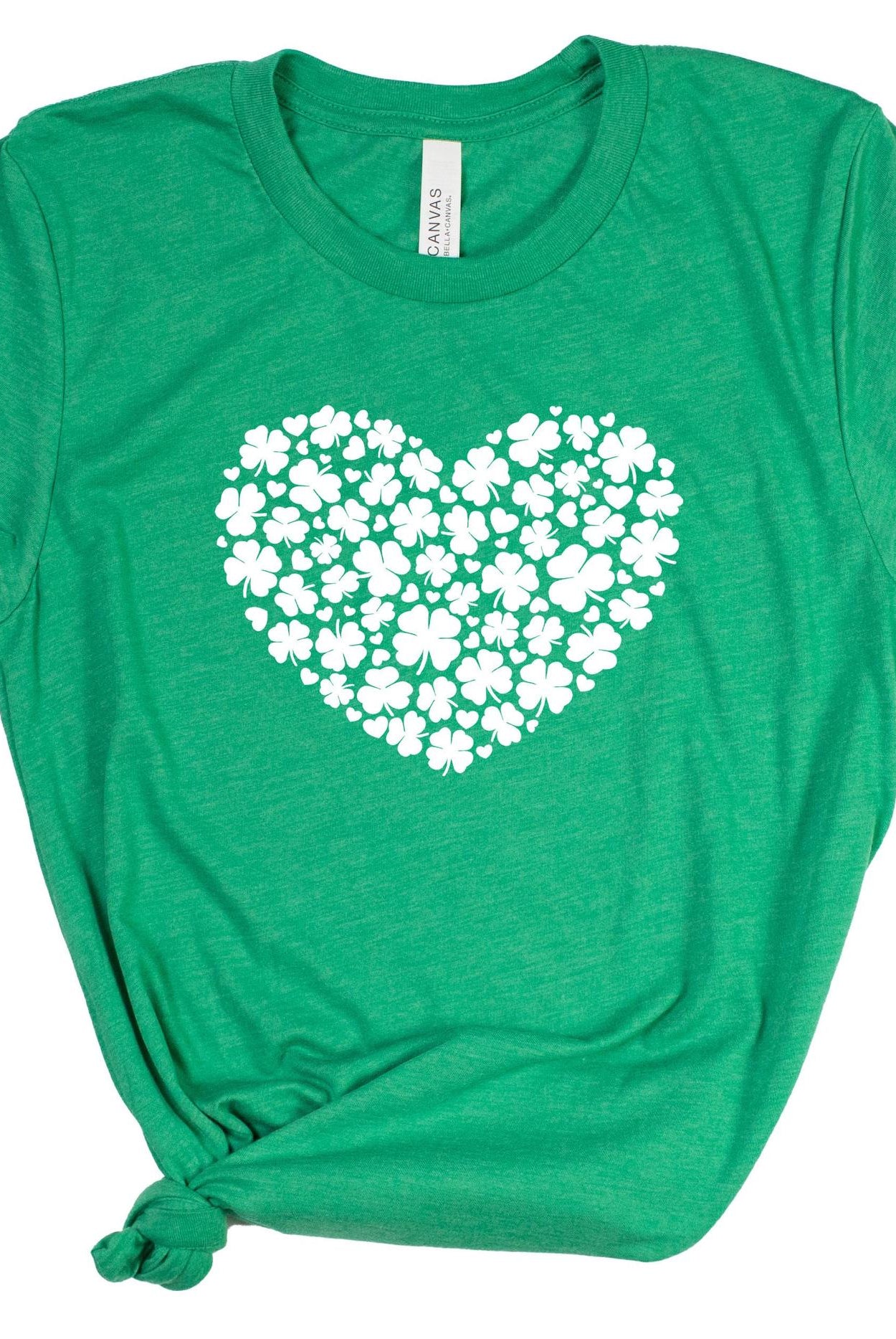 Green t-shirt with a white heart-shaped design of clovers on a white background
