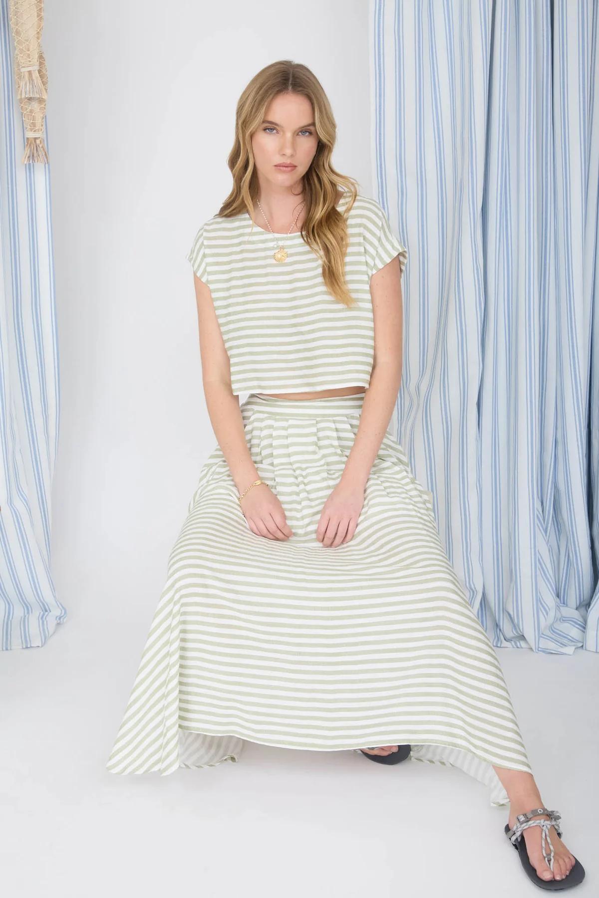 Woman wearing a striped outfit with a white background