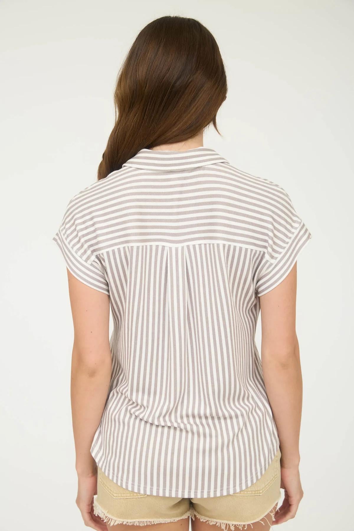 Woman wearing a striped shirt and shorts on a white background