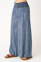 Blue denim wide-leg pants on a white background