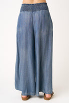Blue denim wide-leg pants on a white background