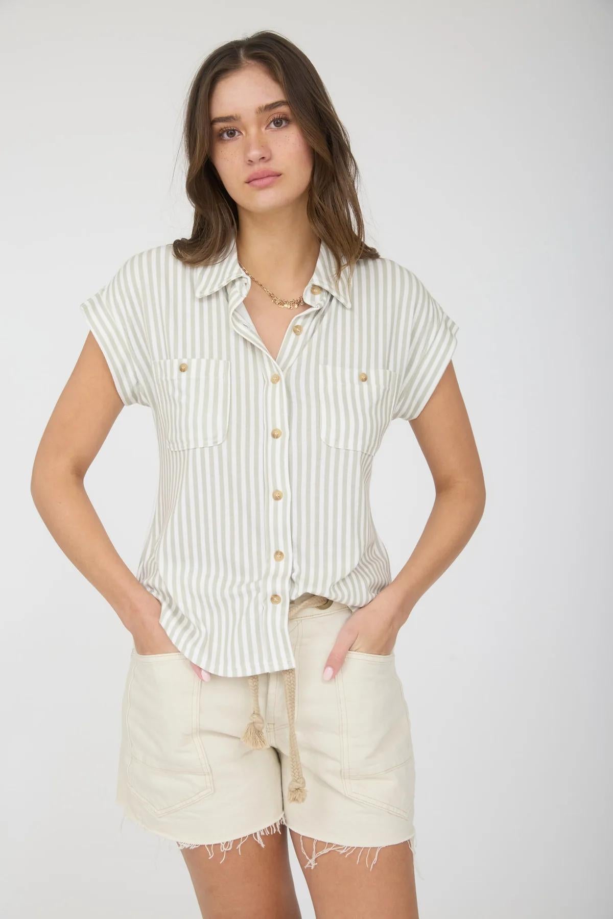 Woman wearing a striped shirt and shorts on a white background