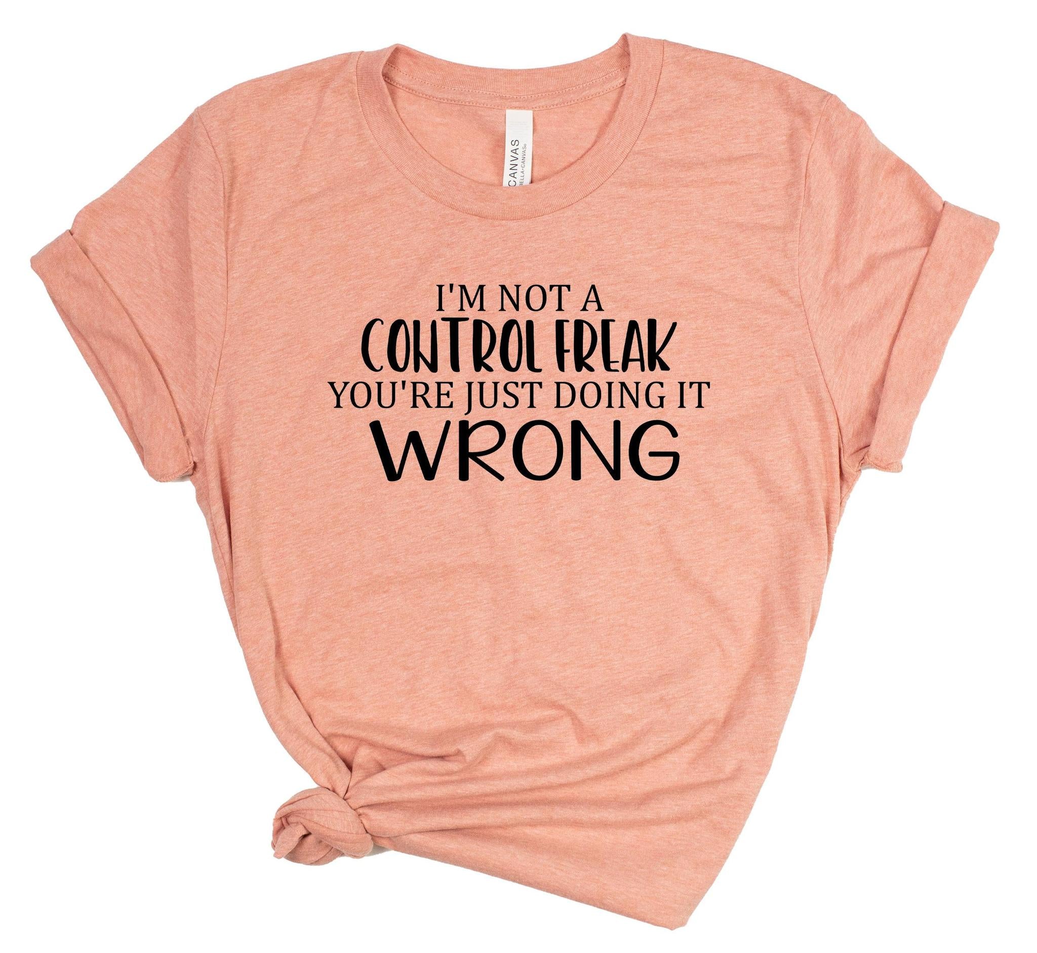 Pink t-shirt with black text on a white background