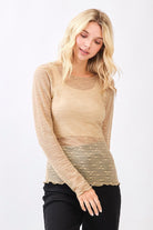 Woman wearing a beige long-sleeve top on a white background