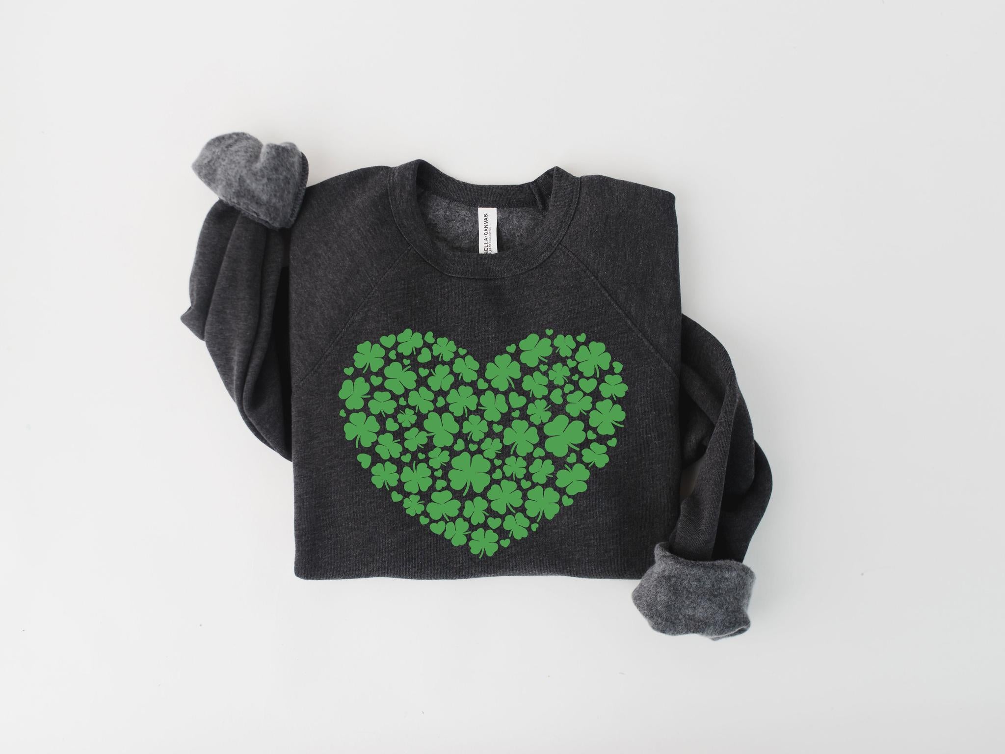 Dark gray sweatshirt with a green heart-shaped pattern of clovers on a light gray background