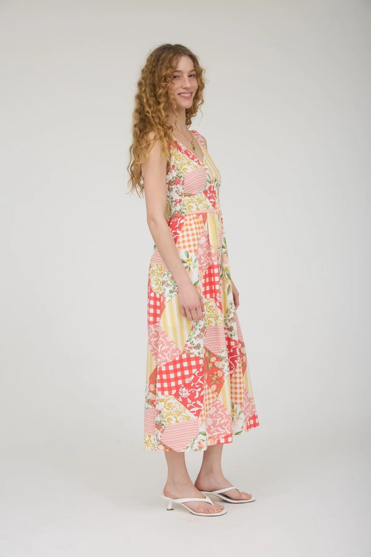 Woman wearing a colorful patchwork dress on a white background
