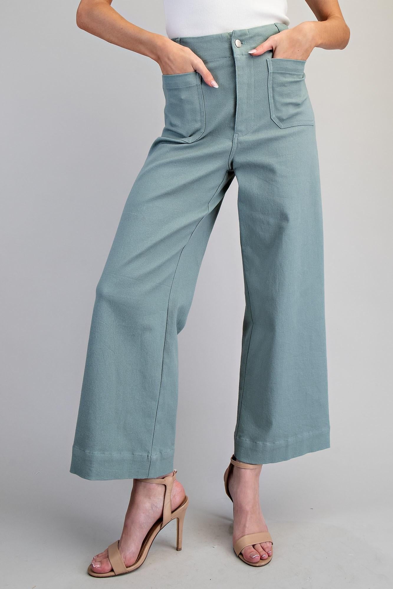 Person wearing light blue jeans on a plain background