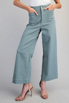 Person wearing light blue jeans on a plain background