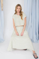 Woman wearing a striped outfit with a white background