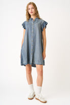 Woman wearing a denim dress on a white background