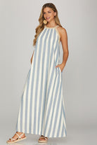 Woman wearing a blue and white striped dress on a gray background