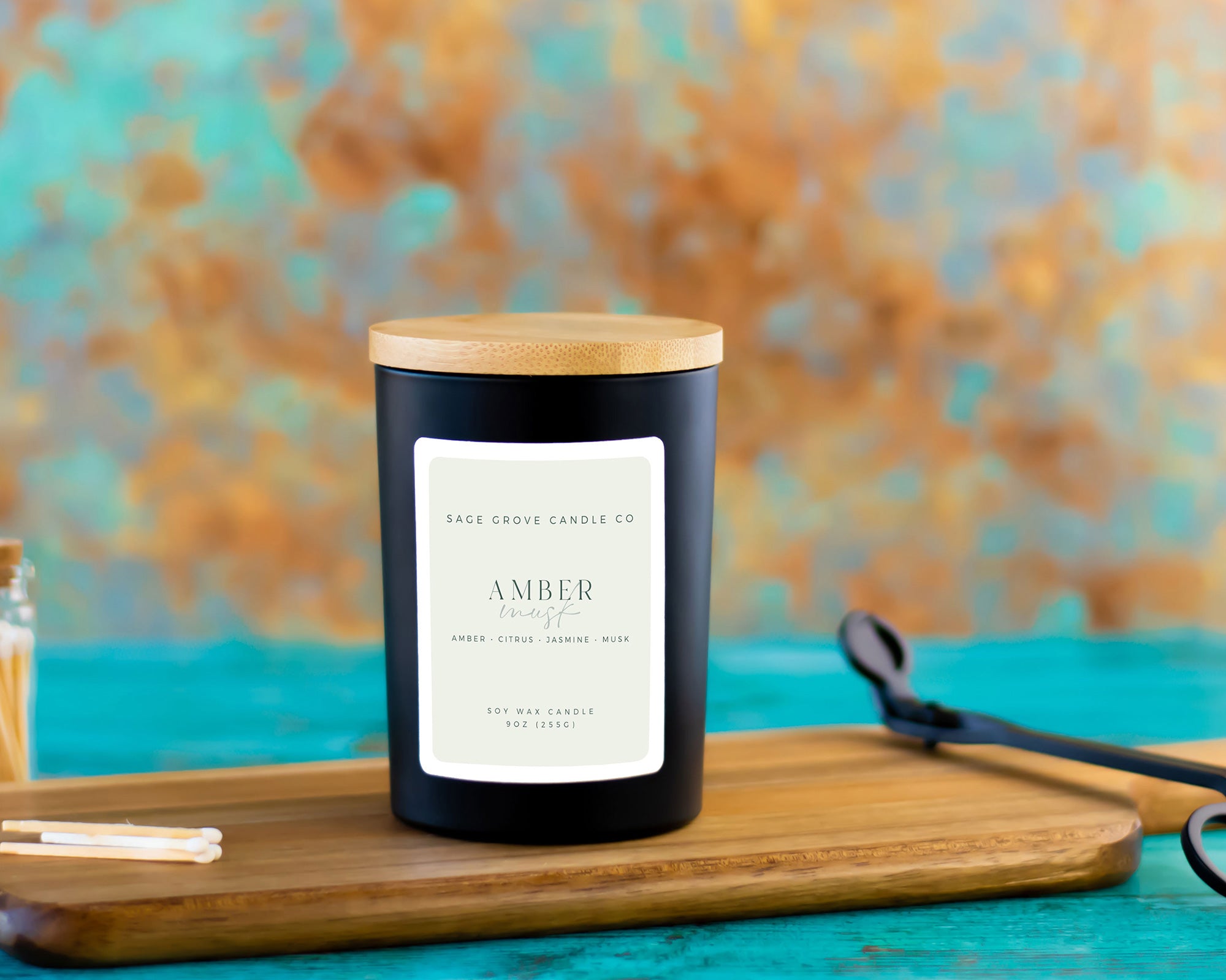 amber musk candle in ceramic jar on wood surface