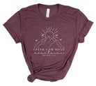 Maroon t-shirt with mountain and sun graphic and 'Faith can move mountains' text on a white background