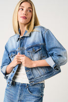 Woman wearing a blue denim jacket on a white background