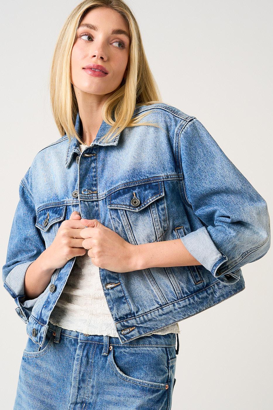 Woman wearing a blue denim jacket on a white background