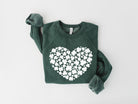Green sweatshirt with a white heart-shaped pattern on a light gray background