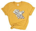 Yellow t-shirt with 'Made in the 70's' text on a white background