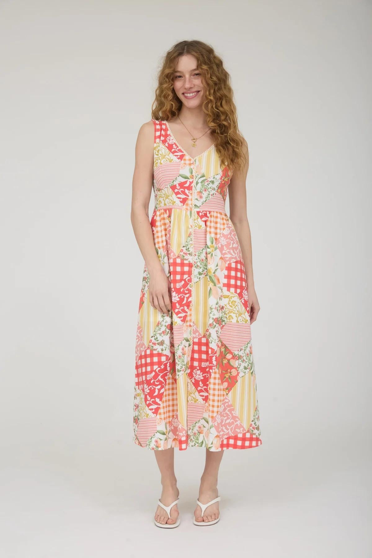 Woman wearing a colorful patterned dress on a white background