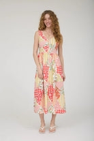 Woman wearing a colorful patterned dress on a white background