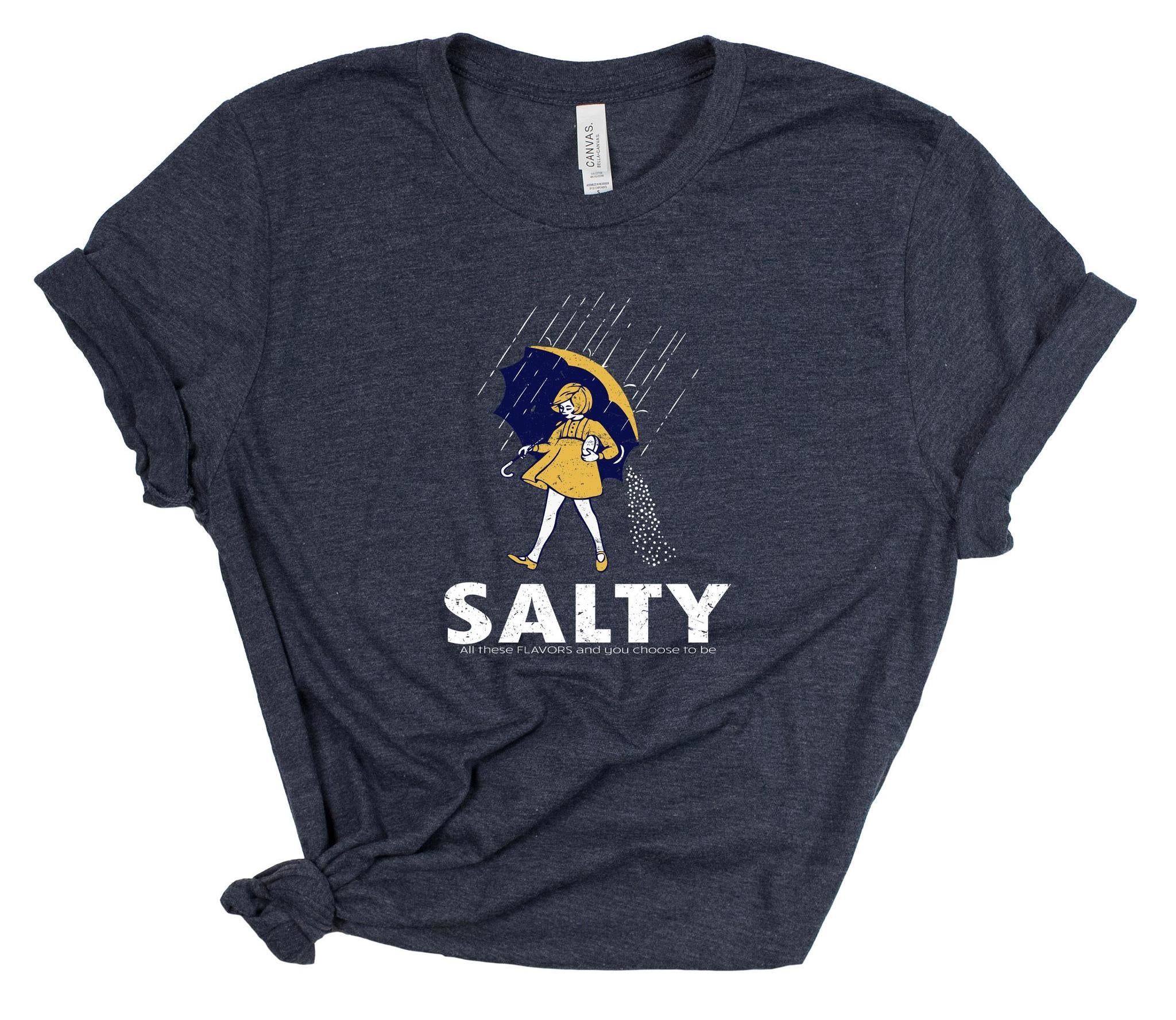 Navy blue t-shirt with 'Salty' graphic design featuring a person with an umbrella on a white background.