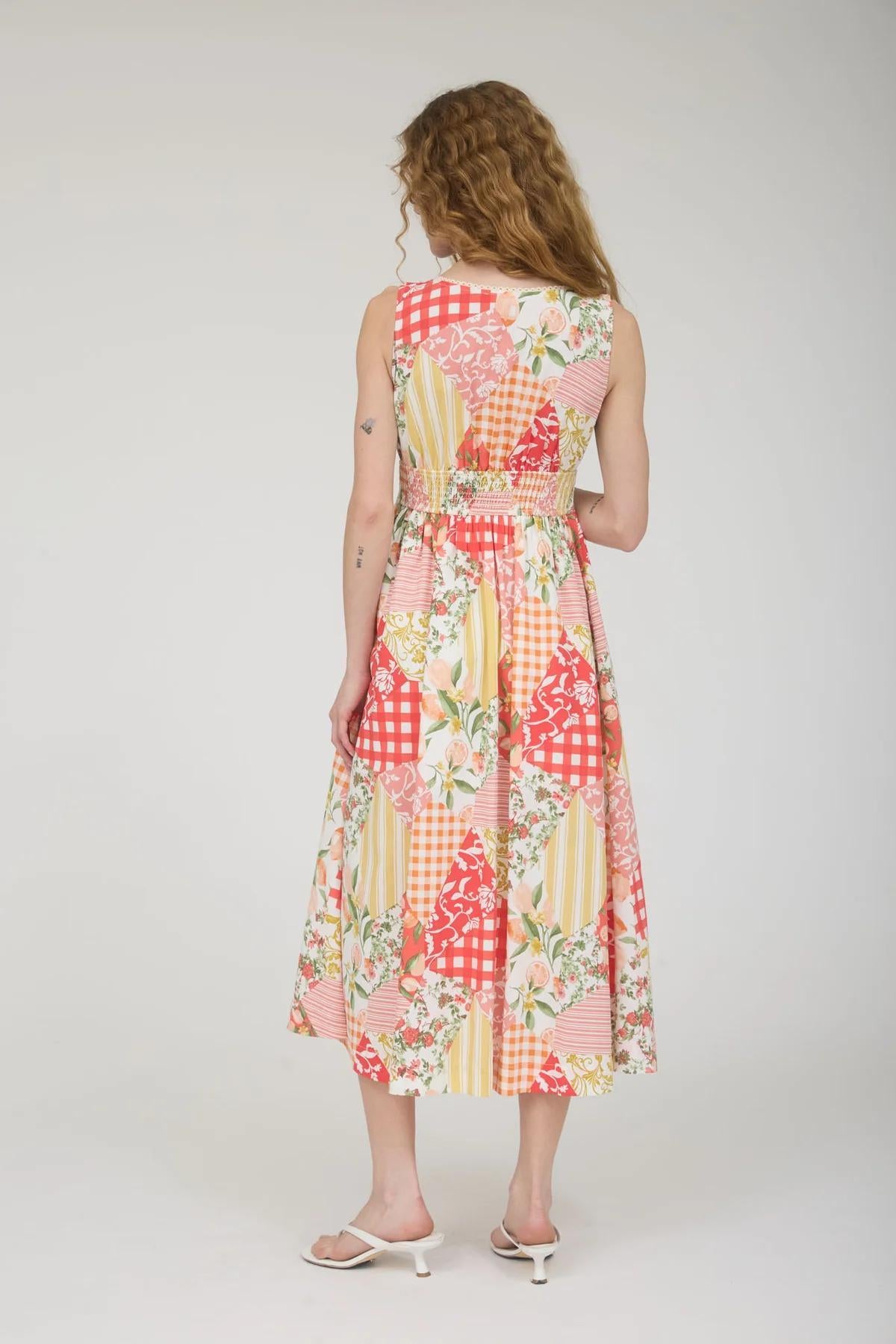Woman wearing a colorful patchwork dress on a white background