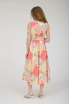 Woman wearing a colorful patchwork dress on a white background